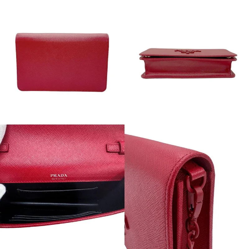 Prada crossbody bags in a vibrant red for a bold fashion statementPRADA Saffiano Shoulder Bag