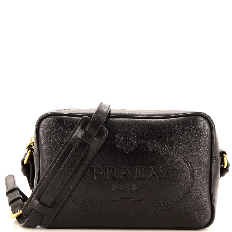 Prada Cleo bags with a contrast - colored interior for visual interestLogo Camera Bag Embossed Leather Small